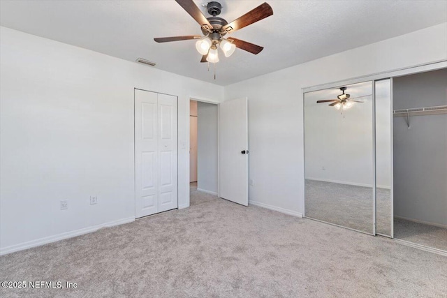 unfurnished bedroom featuring light carpet and ceiling fan