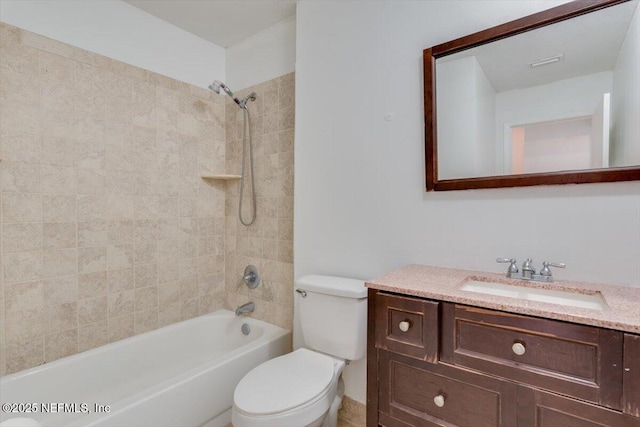 full bathroom featuring vanity, toilet, and tiled shower / bath combo