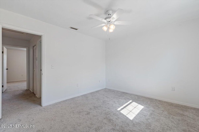 empty room with light colored carpet and ceiling fan