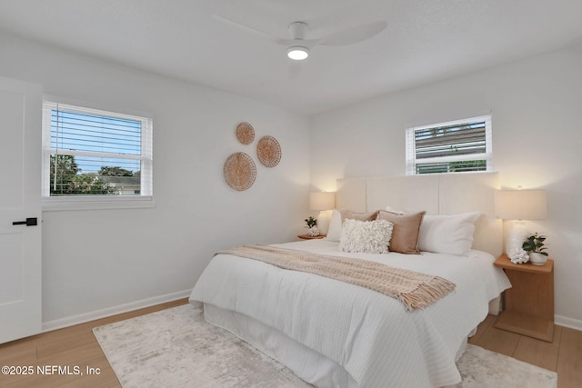 bedroom with ceiling fan and light hardwood / wood-style floors