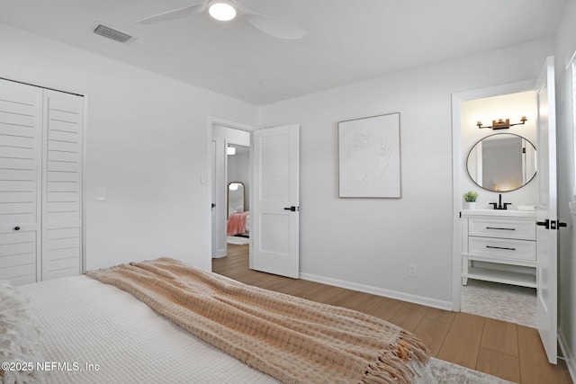 bedroom featuring ceiling fan, light wood-type flooring, and a closet