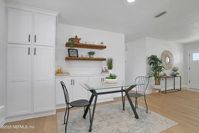 dining space with light wood-type flooring