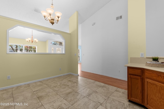 unfurnished dining area featuring vaulted ceiling and a chandelier