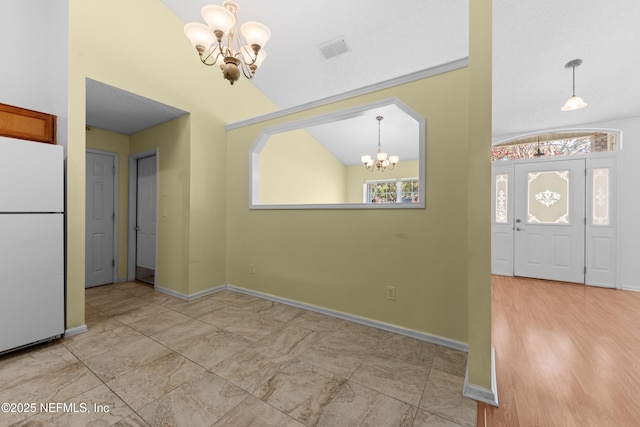 entryway featuring lofted ceiling and a notable chandelier