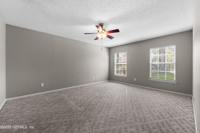 spare room with carpet floors, a textured ceiling, and ceiling fan