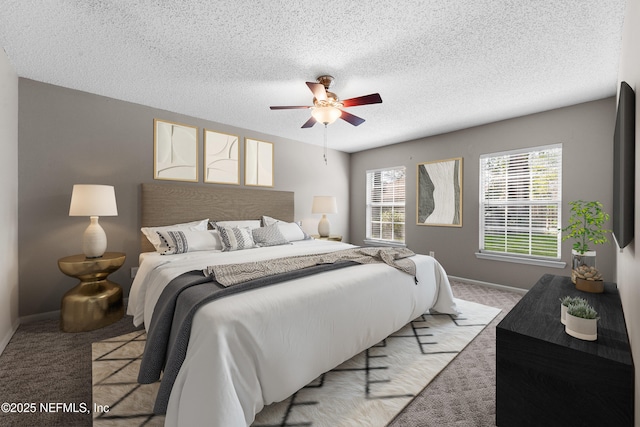 bedroom featuring light colored carpet, a textured ceiling, and ceiling fan