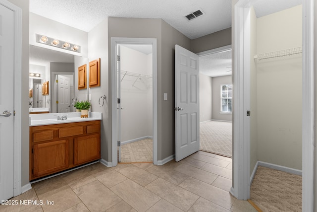 bathroom with vanity and a textured ceiling