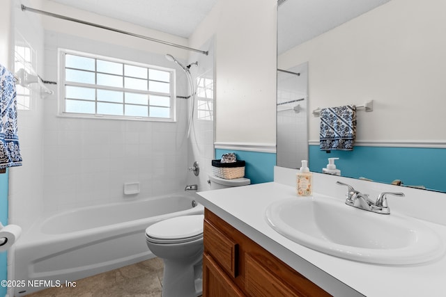 full bathroom featuring tiled shower / bath, vanity, toilet, tile patterned floors, and a textured ceiling