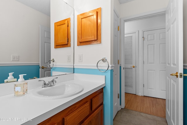 bathroom featuring tile patterned flooring and vanity