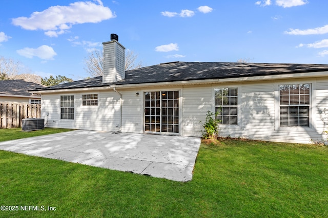 back of property with central AC unit, a yard, and a patio