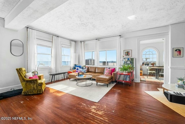 living room with dark wood-type flooring and a textured ceiling