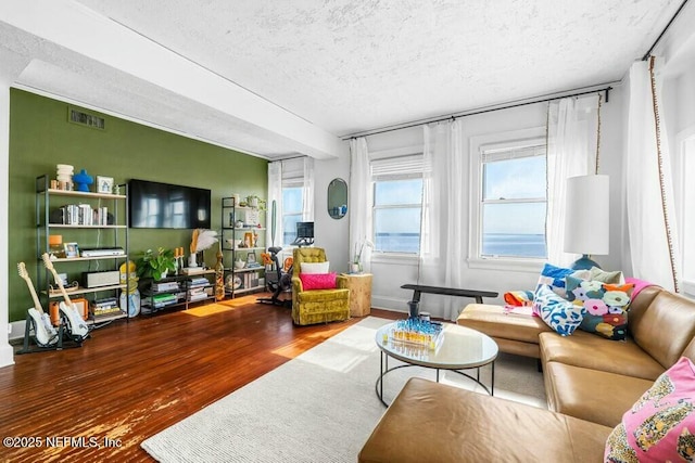 living room with hardwood / wood-style floors and a textured ceiling