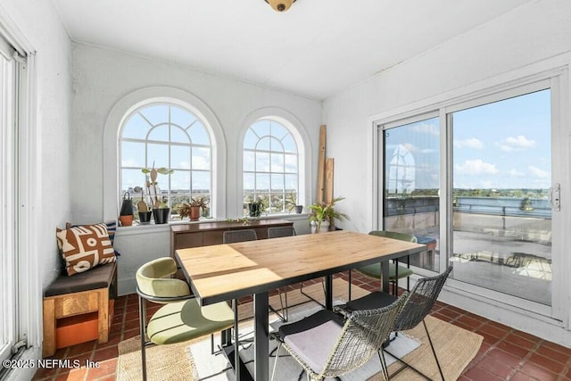 tiled dining room with a water view