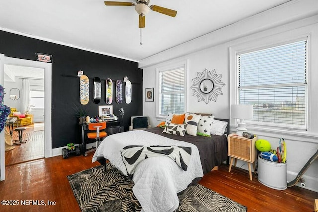 bedroom with dark hardwood / wood-style floors and ceiling fan