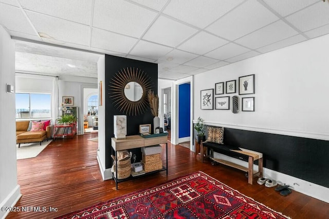 office space with a paneled ceiling and hardwood / wood-style floors