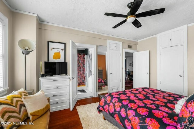 bedroom with crown molding, ceiling fan, dark hardwood / wood-style flooring, and a textured ceiling