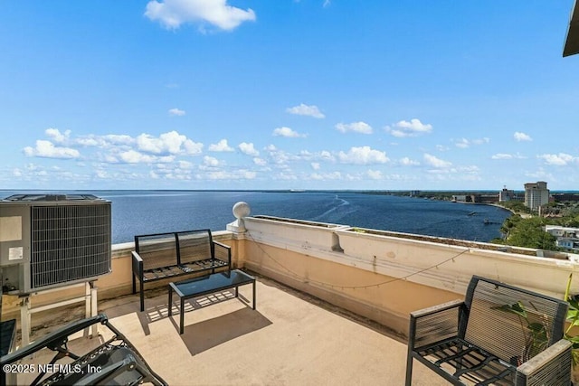 balcony with a water view and central AC unit