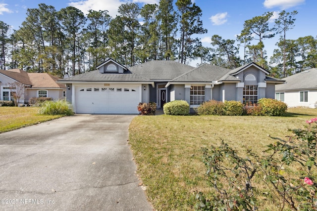 ranch-style house featuring a garage and a front yard