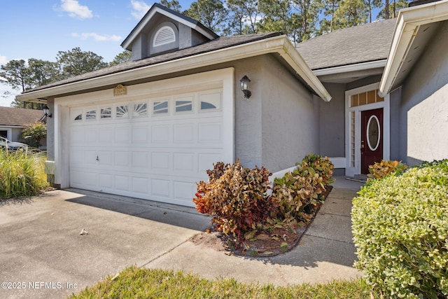 doorway to property with a garage