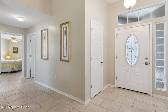 tiled foyer entrance with ceiling fan