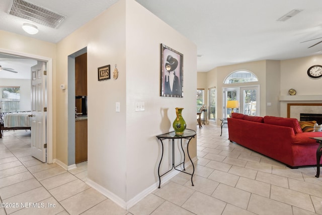 hallway with light tile patterned floors