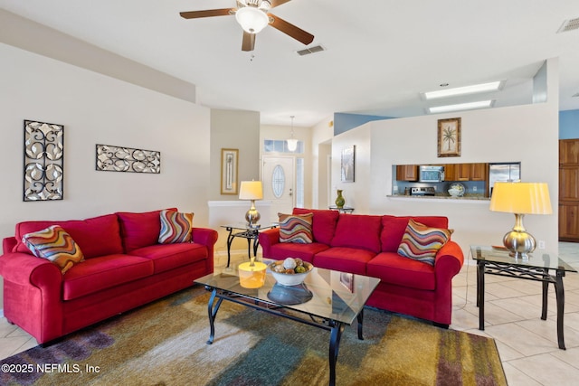 tiled living room with ceiling fan