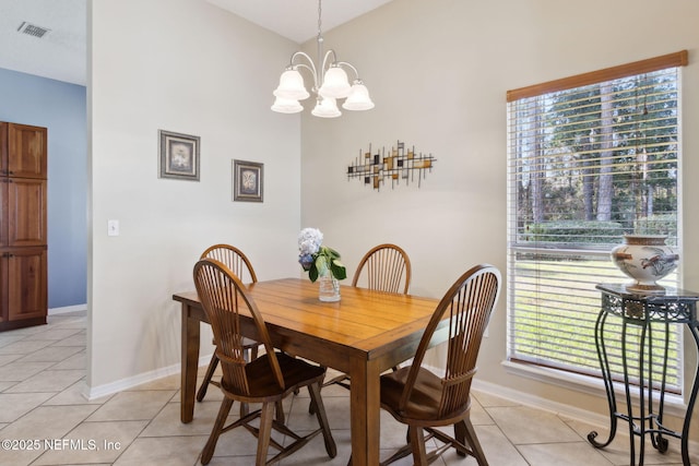 dining room with light tile patterned flooring and a chandelier