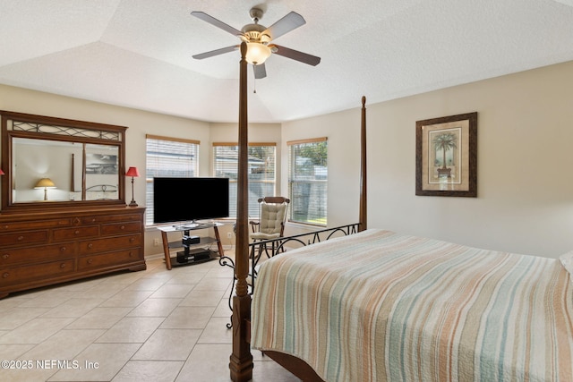 bedroom with light tile patterned floors, a textured ceiling, and ceiling fan