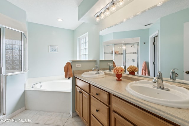 bathroom featuring vanity, tile patterned floors, and plus walk in shower