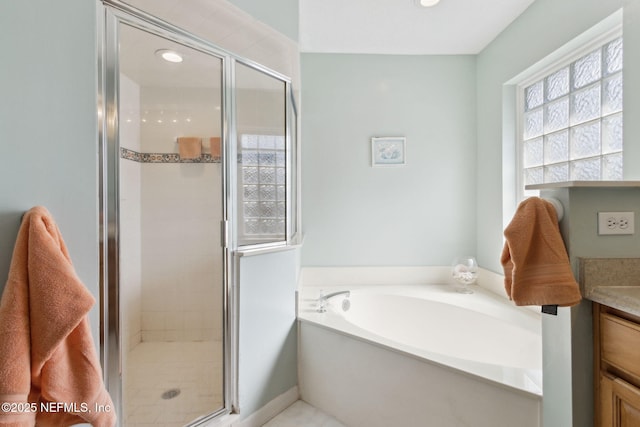 bathroom featuring vanity and separate shower and tub