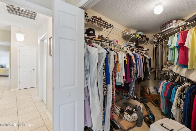 spacious closet featuring light tile patterned floors