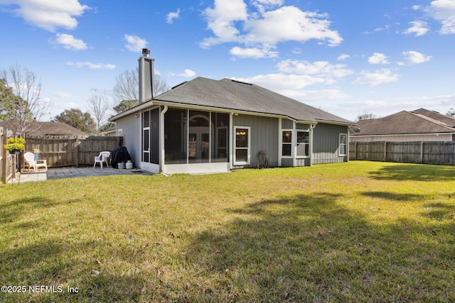 rear view of house with a patio, a sunroom, and a lawn