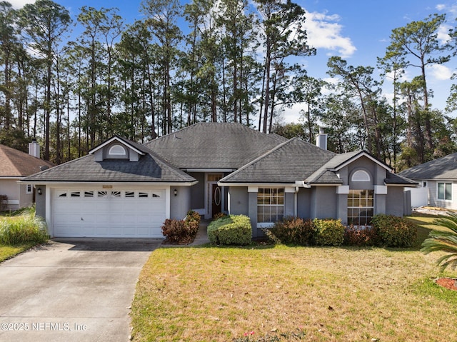 ranch-style home with a garage and a front lawn