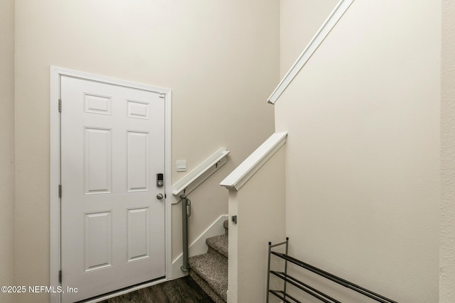 stairs featuring hardwood / wood-style floors