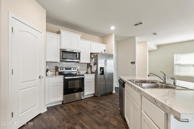 kitchen with white cabinetry, sink, dark hardwood / wood-style flooring, and appliances with stainless steel finishes