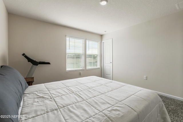 carpeted bedroom with a textured ceiling