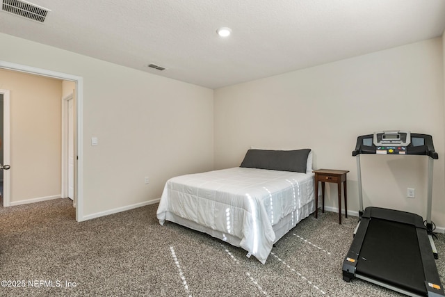 bedroom with dark carpet and a textured ceiling