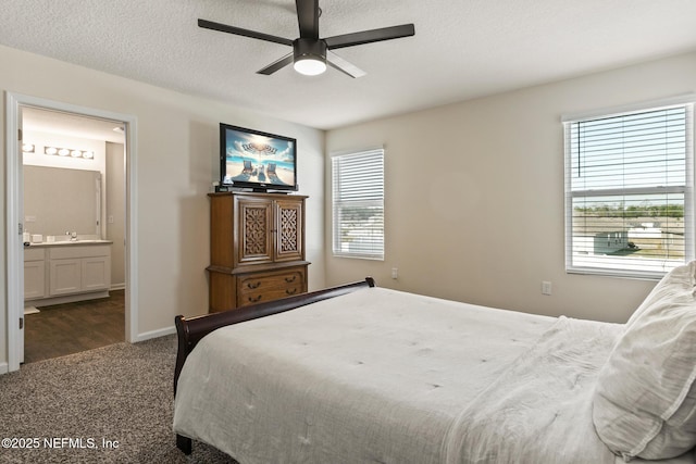 carpeted bedroom with connected bathroom, a textured ceiling, and ceiling fan