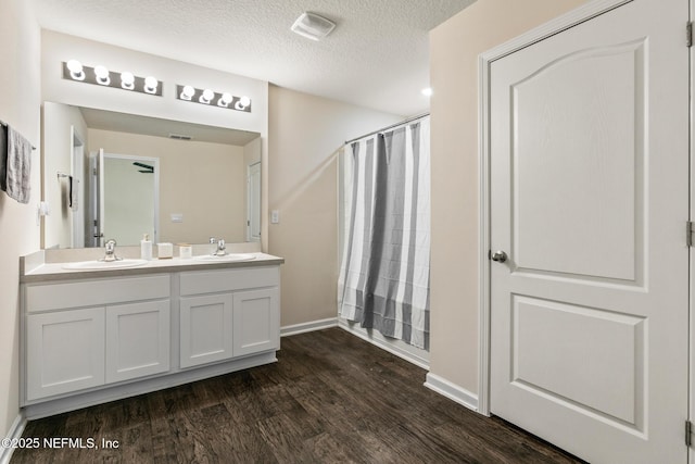 bathroom featuring vanity, a shower with curtain, wood-type flooring, and a textured ceiling