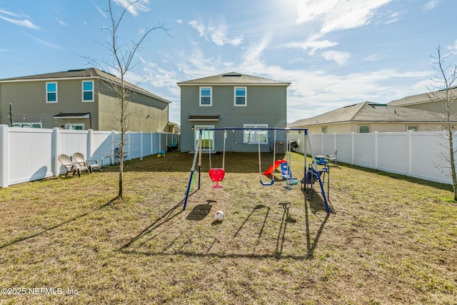 rear view of house with a playground and a lawn