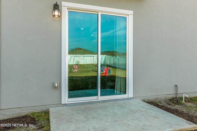 property entrance with a patio area