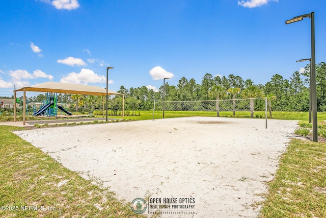 view of home's community with a lawn, volleyball court, and a playground