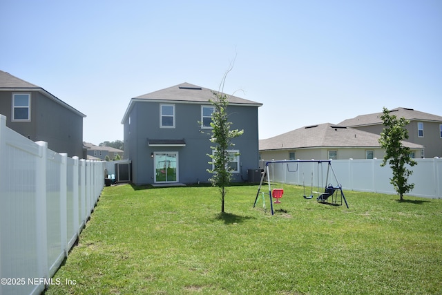 2271 Willow Glen Ln, Green Cove Springs, FL 32043 - back of property featuring a playground, stucco siding, and central AC