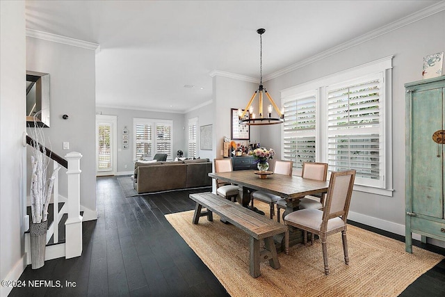 dining area with baseboards, ornamental molding, wood-type flooring, and a notable chandelier