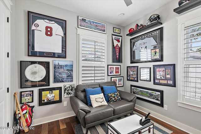 sitting room featuring dark wood-type flooring and baseboards