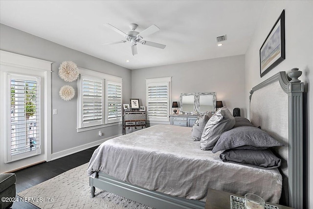 bedroom with visible vents, baseboards, ceiling fan, dark wood-type flooring, and access to exterior