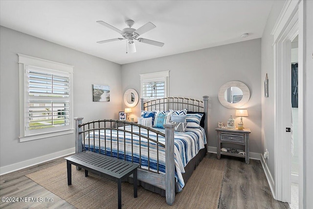 bedroom featuring ceiling fan, baseboards, and wood finished floors