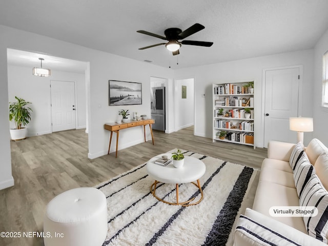 living room with hardwood / wood-style floors and ceiling fan