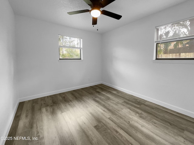 unfurnished room with hardwood / wood-style flooring and ceiling fan