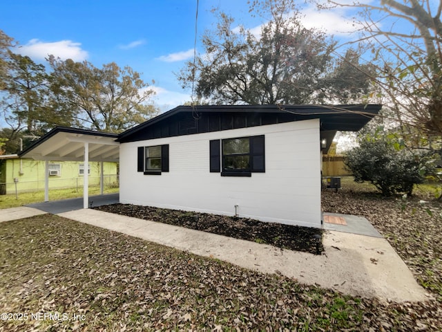 view of side of property featuring a carport